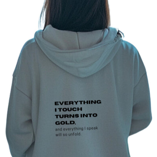 girl wearing everything i touch turns into gold affirmation hoodie.jpg